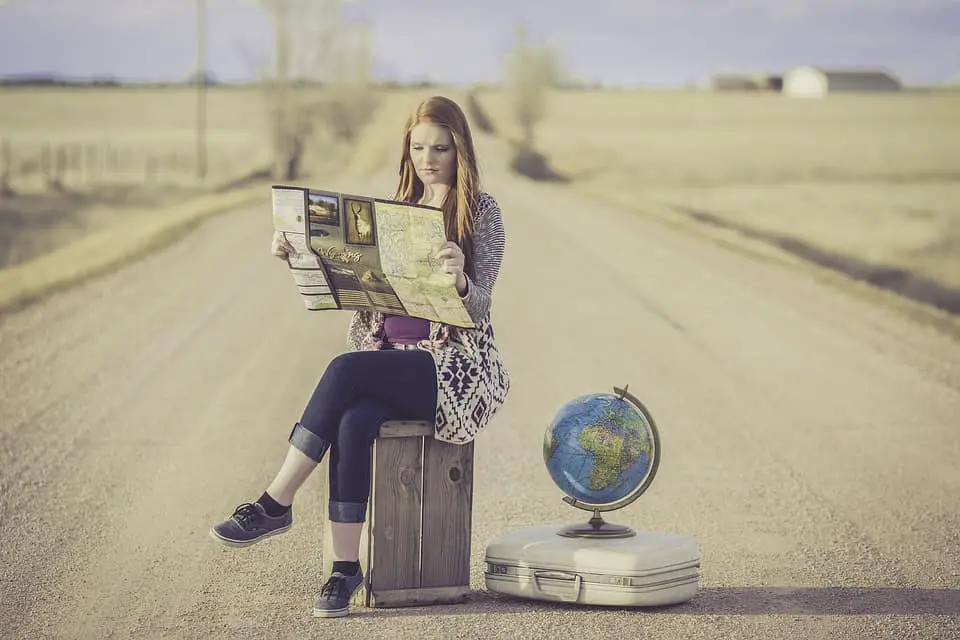 woman reading magazine in the middle of the street