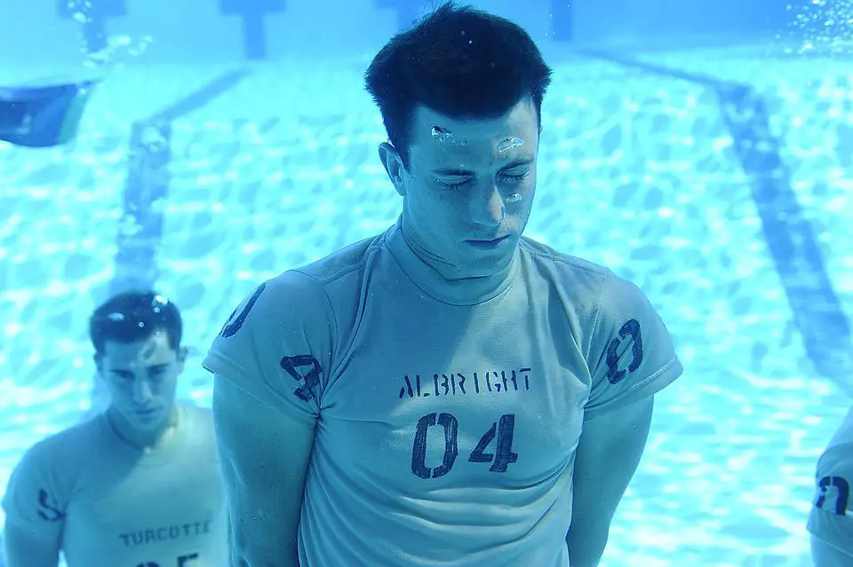 man holding breath underwater