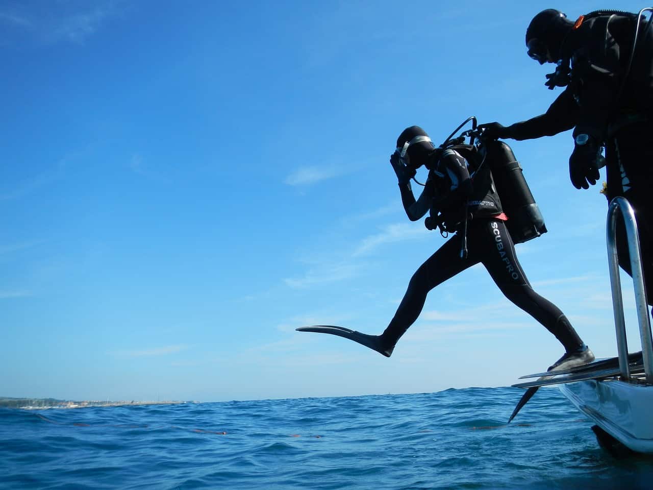 Person wearing a diving gear about to dive