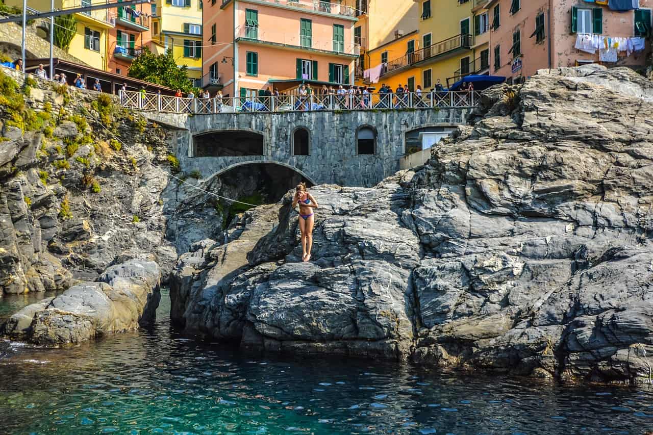 Woman about to dive on a body of water