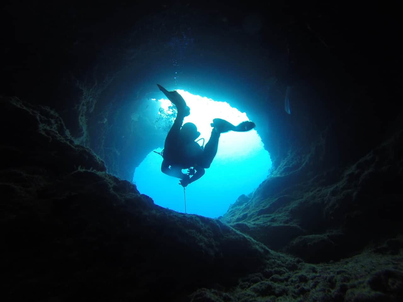 Person swimming on a underwater tunnel