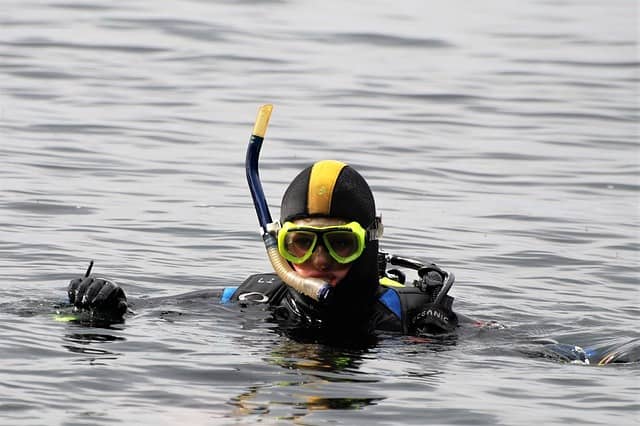 scuba diver wearing scuba mask and other gear
