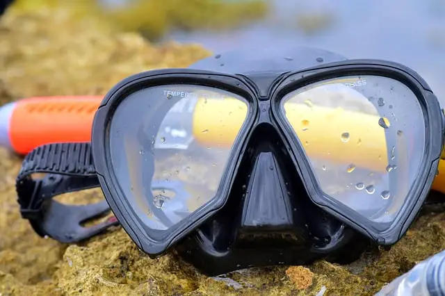 scuba mask on top of a rock