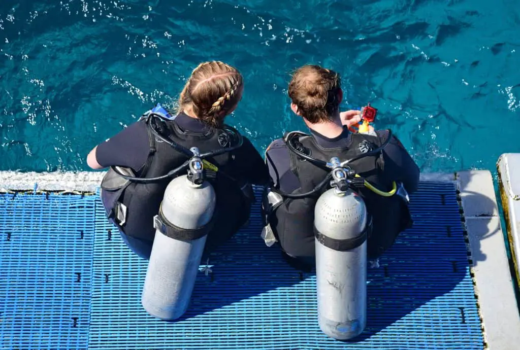 two women preparing to dive into the water